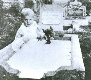 Призрак ребенка, сидящего на могиле ее дочери.