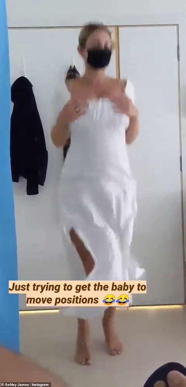 Haha! Ashley later shared a video of herself hopping about it a white maxi dress, as she explained she was trying to get her baby to move positions