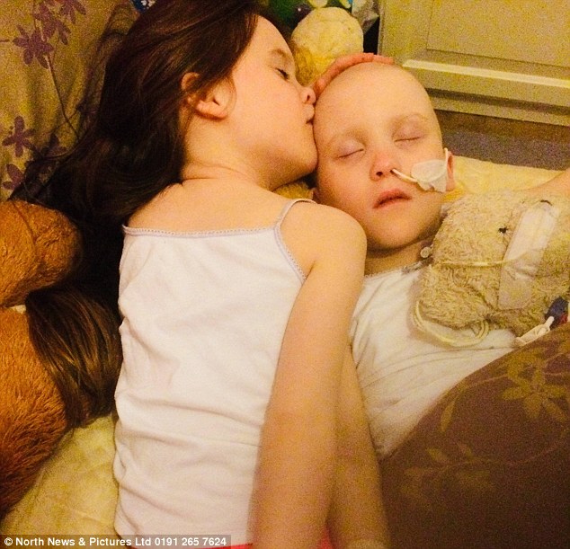 Amelia Wilson (right) was separated from her beloved identical twin Gracie (left) while being forced to live inside a sterile bubble as she battled cancer for the second time