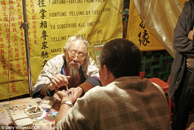 Fortune-telling is commonly seen across China. Palm reading (pictured) is a popular method