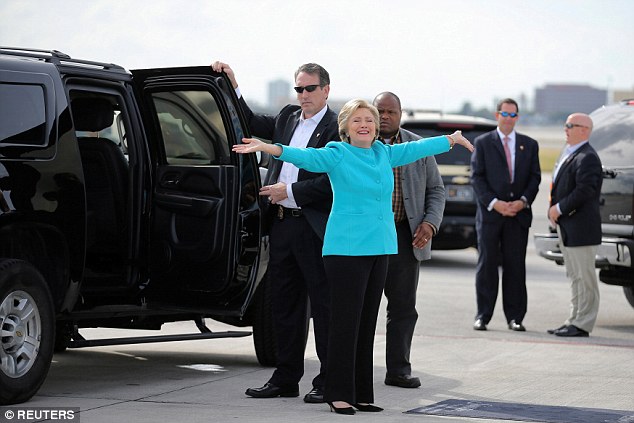 Hillary Clinton gives herself a good stretch as she boards her campaign plane at Miami airport
