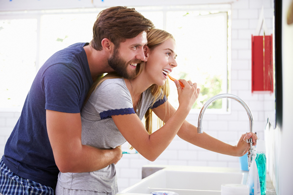 Scorpio Man And His Girlfriend In Pajamas Brushing Teeth In Bathroom