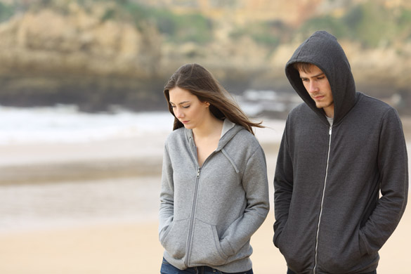 Couple of angry and sad teenagers together walking on the beach - How Can You Tell a Scorpio Man Is Done With You
